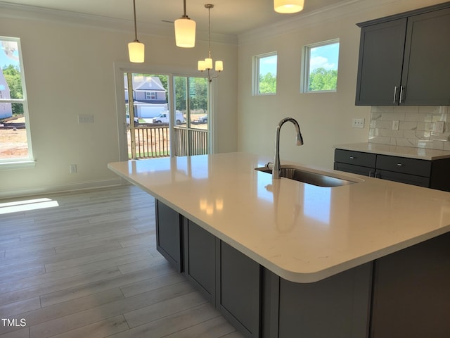 3703 Cessna Way Unit 9, Wilson, NC 27896 - kitchen featuring a sink, ornamental molding, light wood-style flooring, light countertops, and gray cabinets