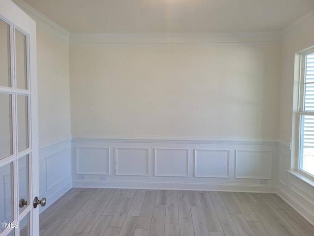 3703 Cessna Way Unit 9, Wilson, NC 27896 - spare room with light wood finished floors, a wainscoted wall, plenty of natural light, a decorative wall, and crown molding