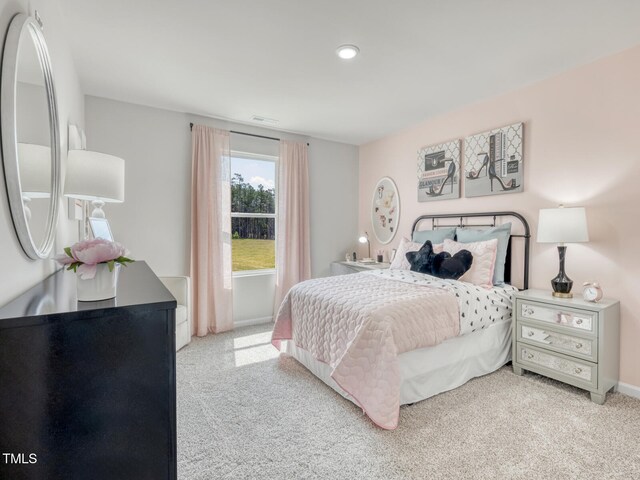 bedroom featuring light carpet, visible vents, and baseboards