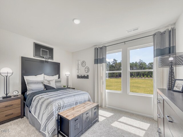 bedroom featuring light carpet, visible vents, and baseboards