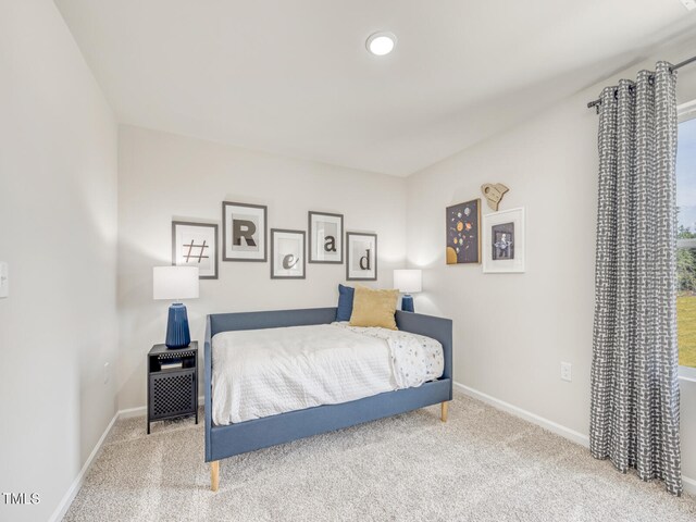 bedroom with baseboards and carpet floors