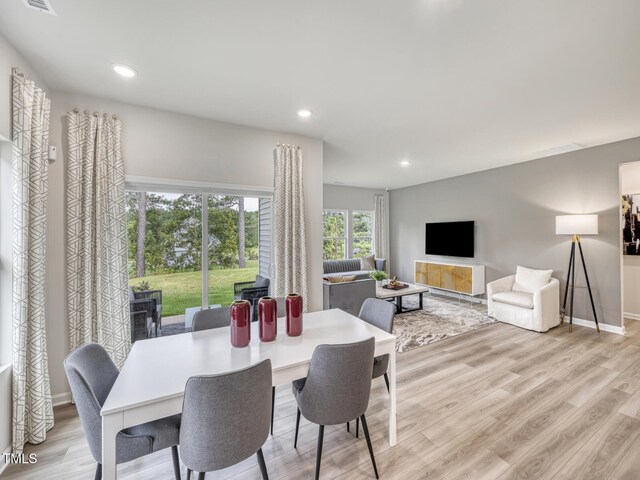 dining space with recessed lighting, visible vents, baseboards, and wood finished floors