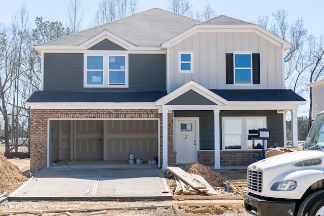 view of front of house featuring brick siding, board and batten siding, and driveway