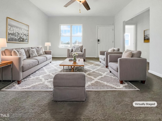 carpeted living area with baseboards and a ceiling fan