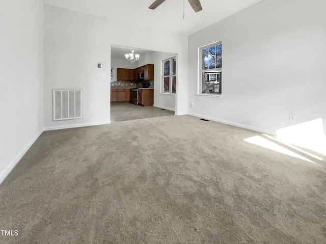 unfurnished living room featuring light carpet, ceiling fan with notable chandelier, visible vents, and baseboards