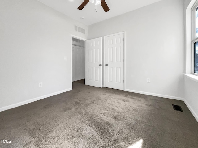 unfurnished bedroom with carpet, visible vents, and baseboards