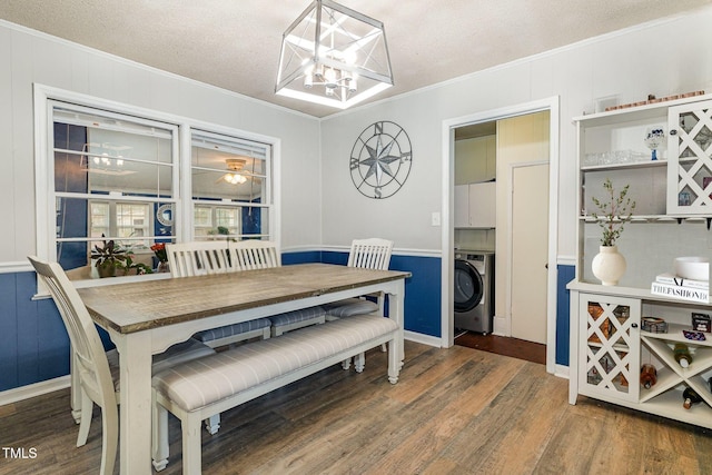 dining area with washer / dryer, crown molding, a textured ceiling, and wood finished floors