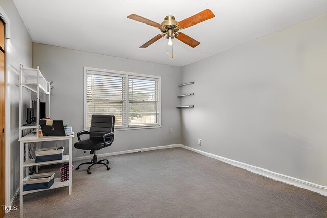 carpeted home office with baseboards and a ceiling fan