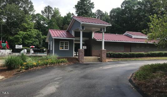 view of front facade with a standing seam roof, fence, and metal roof