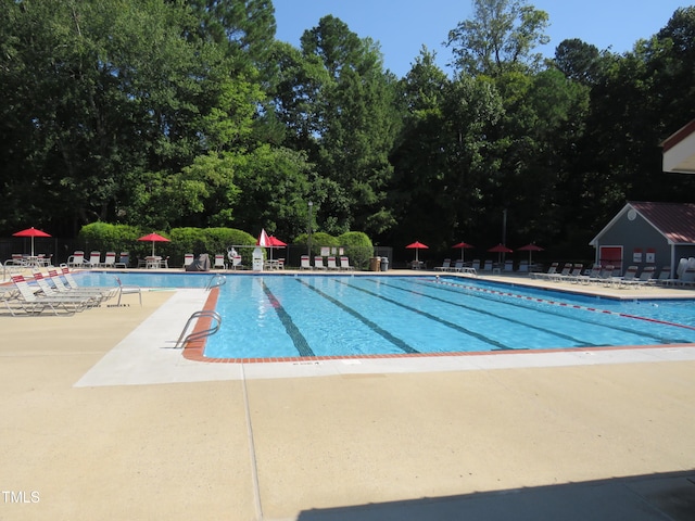 pool with fence and a patio area