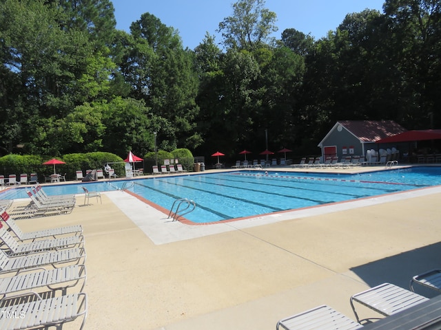 community pool featuring fence and a patio area