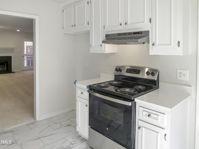 kitchen featuring light countertops, electric stove, marble finish floor, and under cabinet range hood