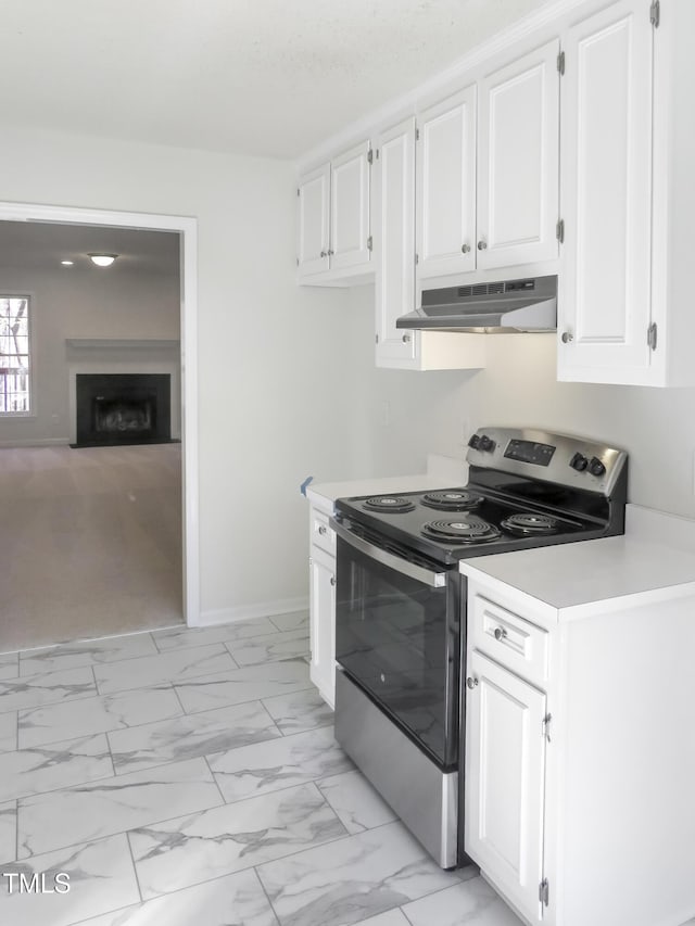 kitchen featuring white cabinets, stainless steel electric stove, marble finish floor, and under cabinet range hood