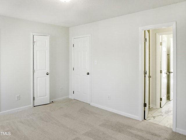 unfurnished bedroom with baseboards and carpet