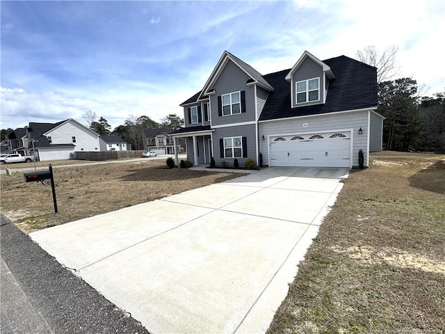 traditional home with concrete driveway and an attached garage