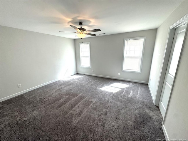 unfurnished room featuring carpet flooring, ceiling fan, visible vents, and baseboards