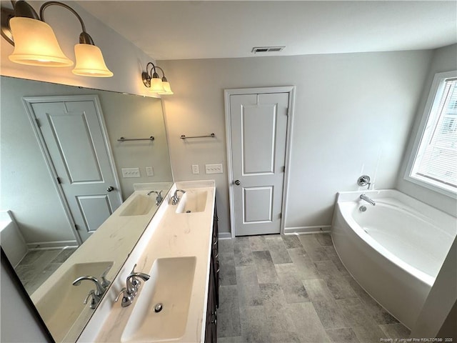 full bathroom with double vanity, visible vents, and a sink