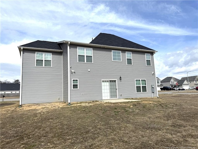 rear view of property with a lawn