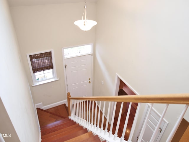 stairway featuring wood finished floors and baseboards