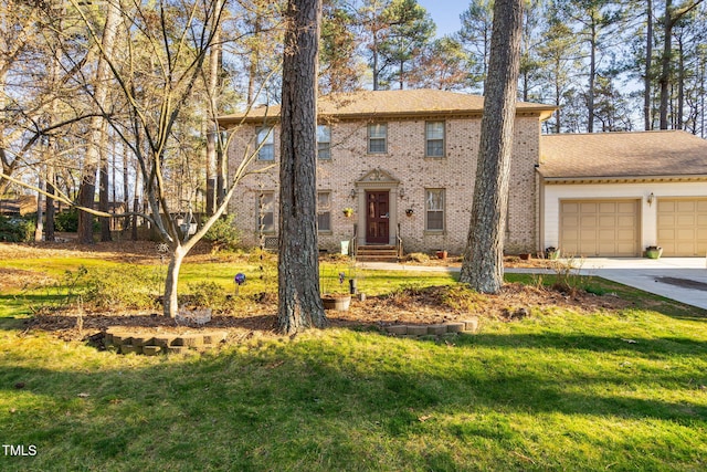 colonial house with a garage, driveway, brick siding, and a front yard
