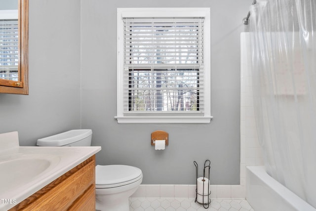 full bathroom featuring tile patterned flooring, vanity, toilet, and shower / bath combo