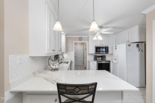 kitchen featuring stainless steel appliances, a peninsula, a sink, white cabinets, and tasteful backsplash