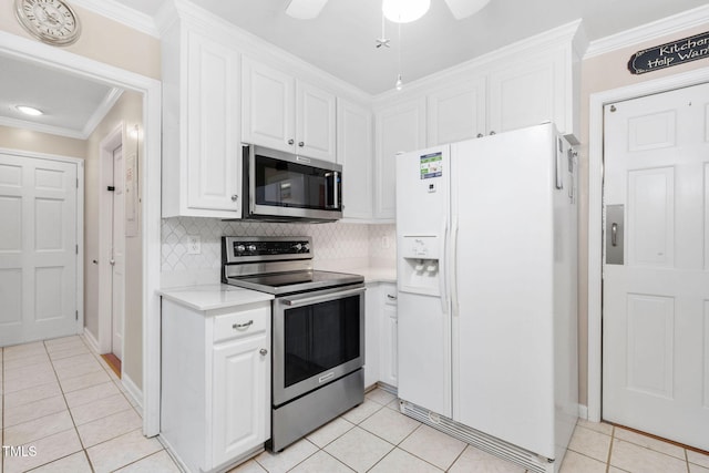 kitchen featuring appliances with stainless steel finishes, light countertops, ornamental molding, and white cabinetry