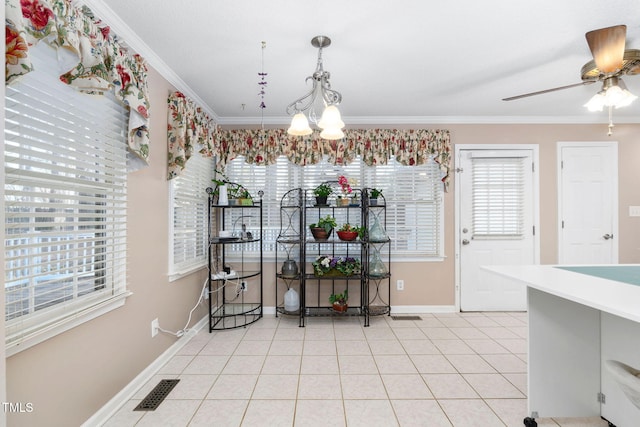 dining area featuring light tile patterned floors, visible vents, ornamental molding, baseboards, and ceiling fan with notable chandelier