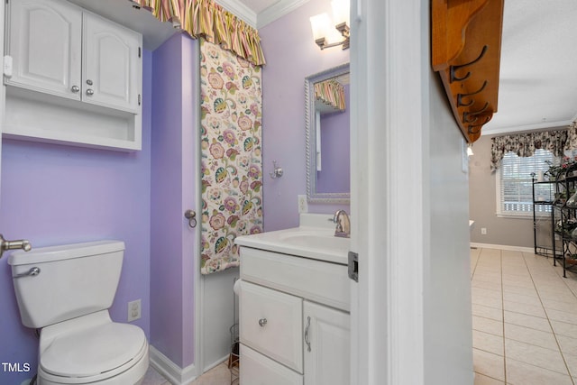bathroom with vanity, tile patterned floors, toilet, and crown molding