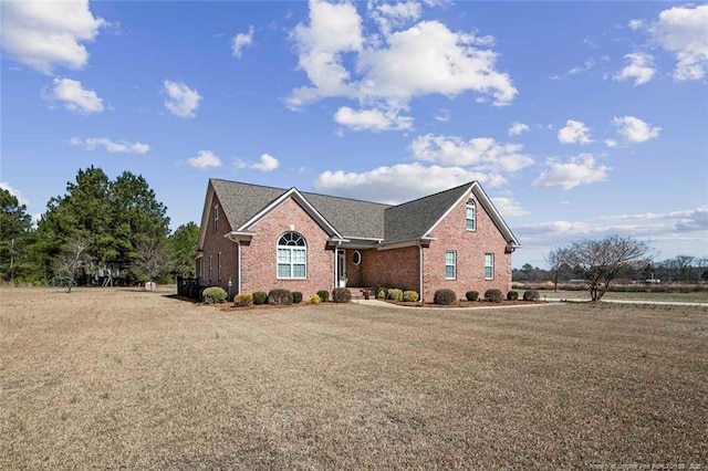 view of front of property with a front yard and brick siding