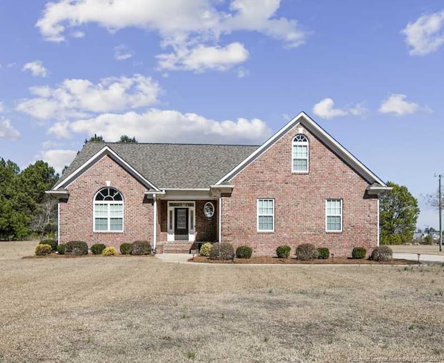 single story home featuring brick siding