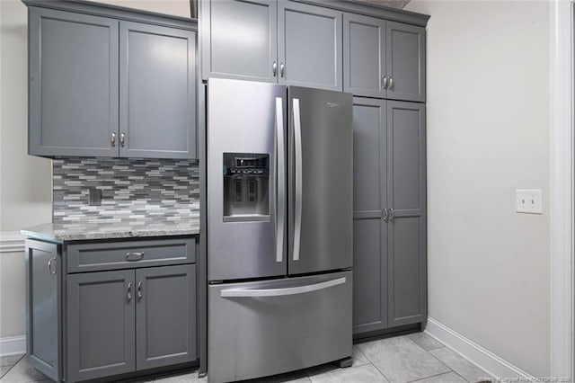 4305 Sanderosa Rd, Fayetteville, NC 28312 - kitchen with baseboards, stainless steel refrigerator with ice dispenser, backsplash, and gray cabinetry