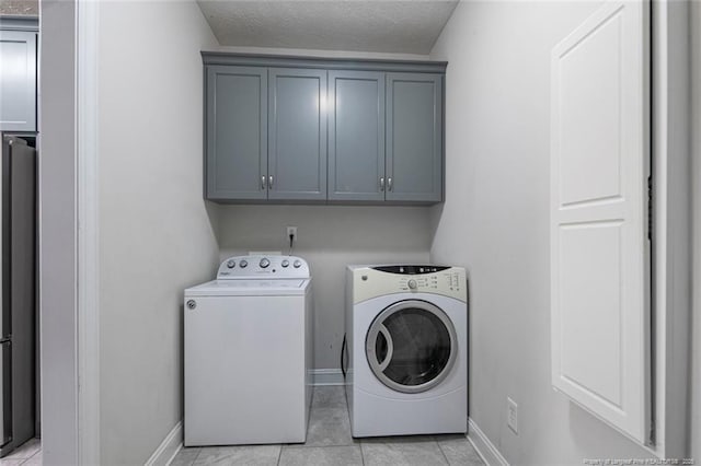 4305 Sanderosa Rd, Fayetteville, NC 28312 - washroom with a textured ceiling, light tile patterned floors, baseboards, washer and dryer, and cabinet space