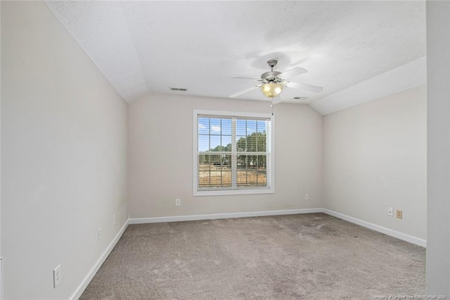 4305 Sanderosa Rd, Fayetteville, NC 28312 - spare room with a textured ceiling, ceiling fan, lofted ceiling, carpet flooring, and baseboards