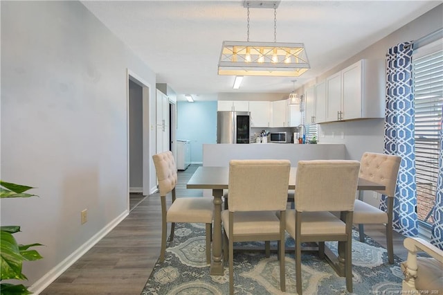 dining space with dark wood-style floors and baseboards