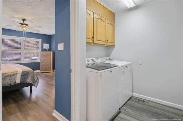 laundry area featuring cabinet space, a ceiling fan, a textured ceiling, wood finished floors, and independent washer and dryer