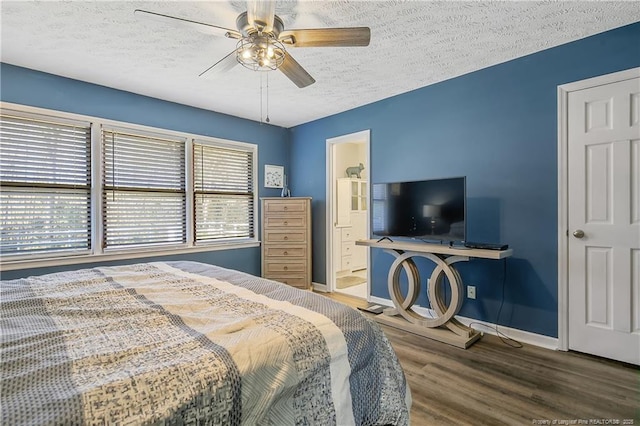 bedroom with a ceiling fan, a textured ceiling, baseboards, and wood finished floors