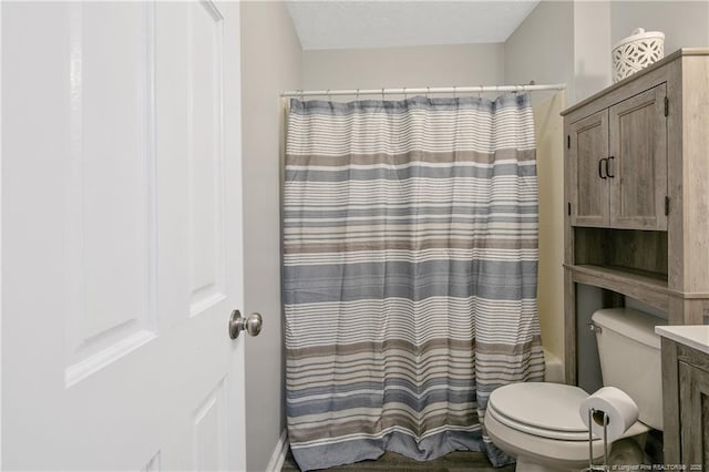 bathroom featuring shower / tub combo and toilet