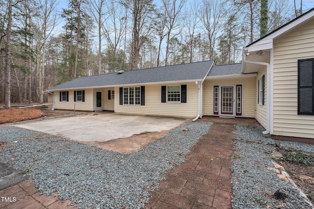 ranch-style house featuring driveway and a patio area