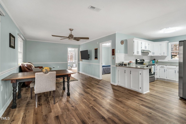 dining space with ceiling fan, visible vents, crown molding, and wood finished floors