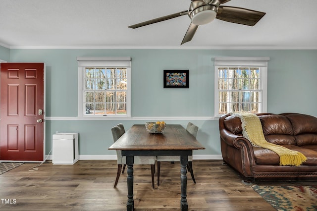 dining space featuring crown molding, plenty of natural light, and wood finished floors