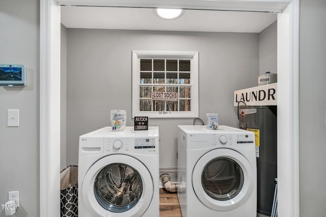 laundry area featuring laundry area, water heater, and washer and clothes dryer