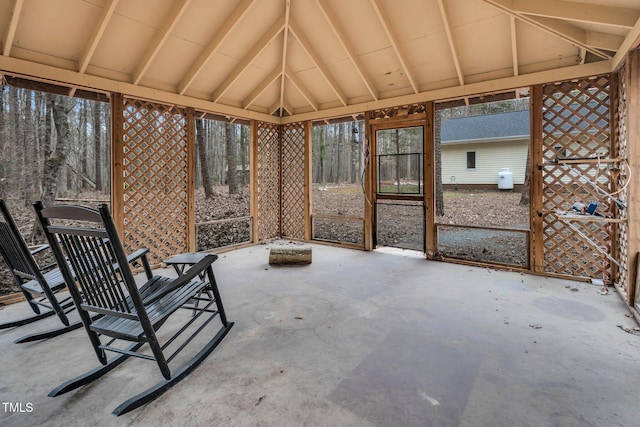 unfurnished sunroom featuring lofted ceiling