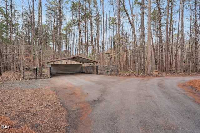 view of outbuilding featuring a carport and driveway