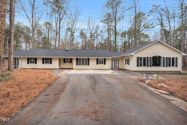 single story home featuring aphalt driveway