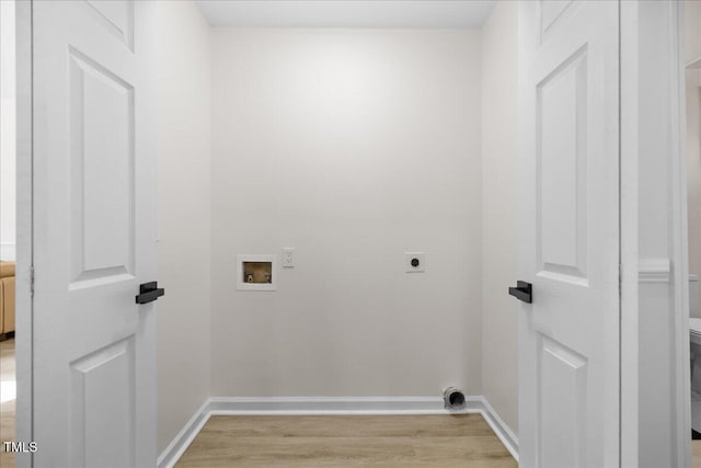 laundry room featuring hookup for a washing machine, light wood-style flooring, electric dryer hookup, and baseboards