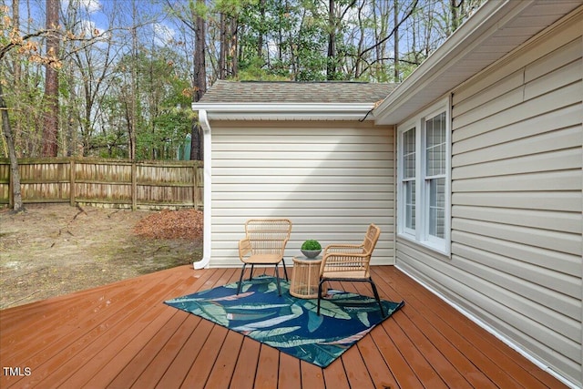 wooden terrace featuring fence