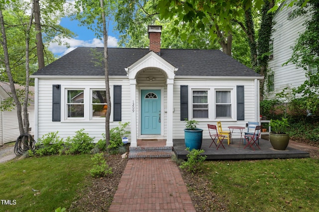 1209 Eva St, Durham, NC 27703 - view of front of house featuring a chimney, a shingled roof, and a front yard