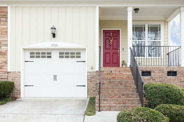 entrance to property with concrete driveway and brick siding