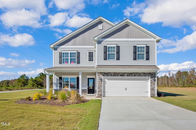 view of front facade with a garage, driveway, a front lawn, and stone siding